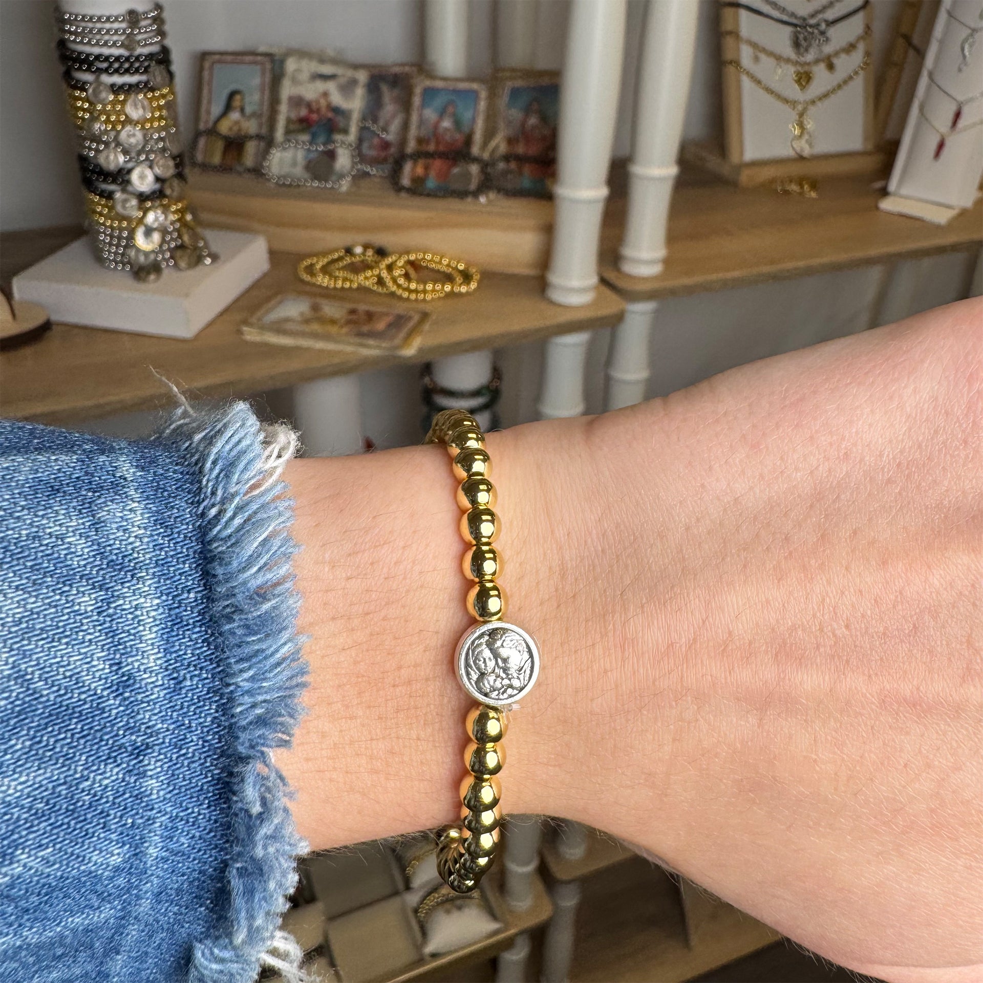 Holy family prayer bracelet gold beaded on model