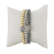 subliminal saint michael the archangel bracelet displayed on pillow gold and silver love lisa