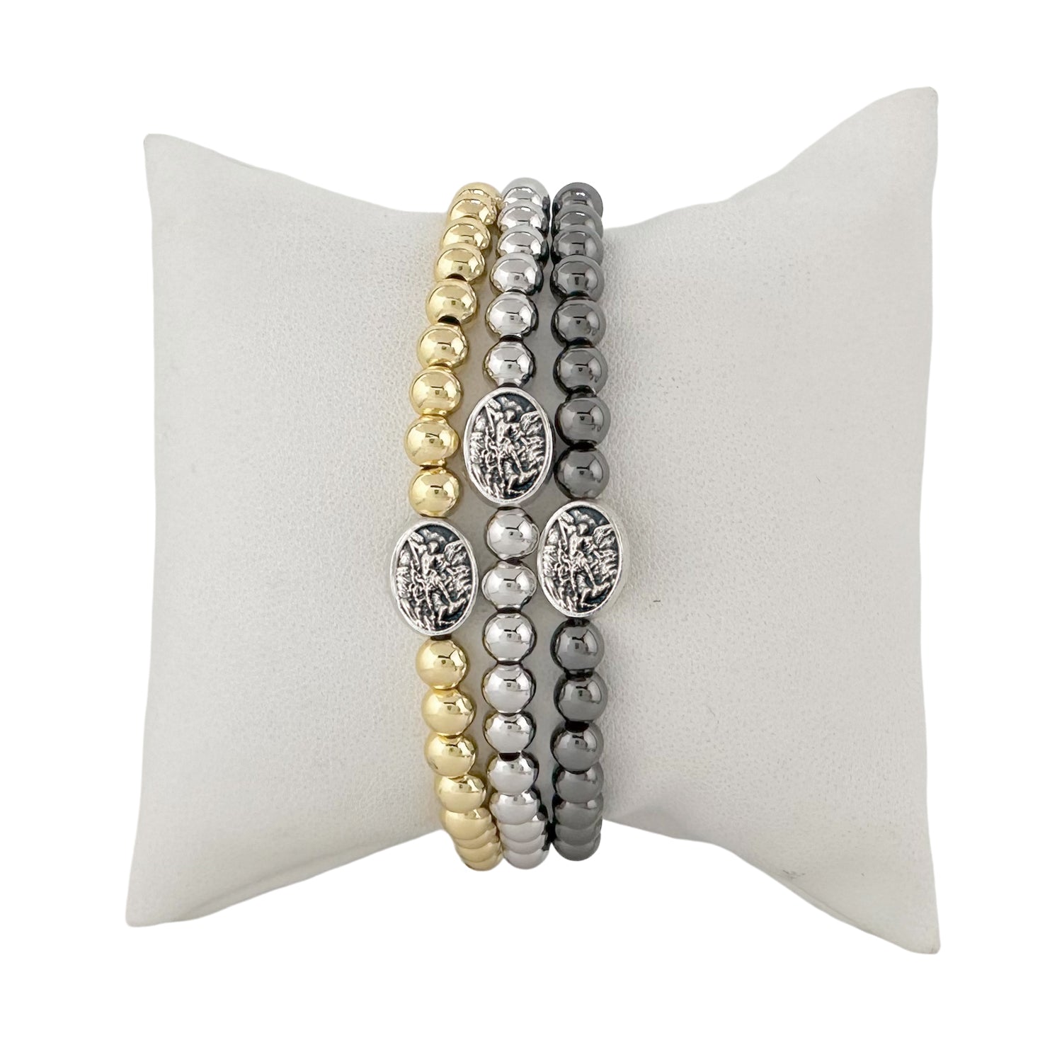 subliminal saint michael the archangel bracelet displayed on pillow gold and silver love lisa