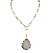 Gold chain necklace with a pendant on a white background