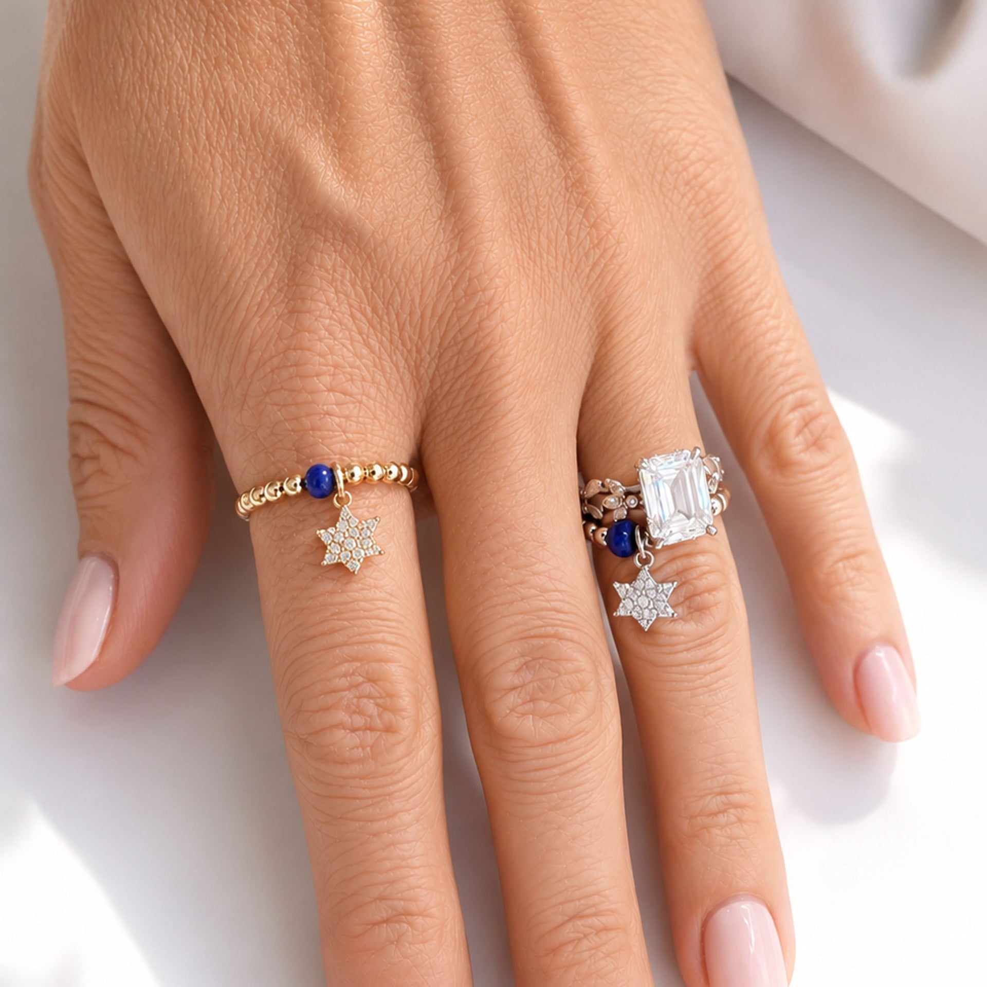 Love Lisa Talia Star of David Stretch Ring worn on hand in gold with blue crystal accent and pavé Star of David charm
