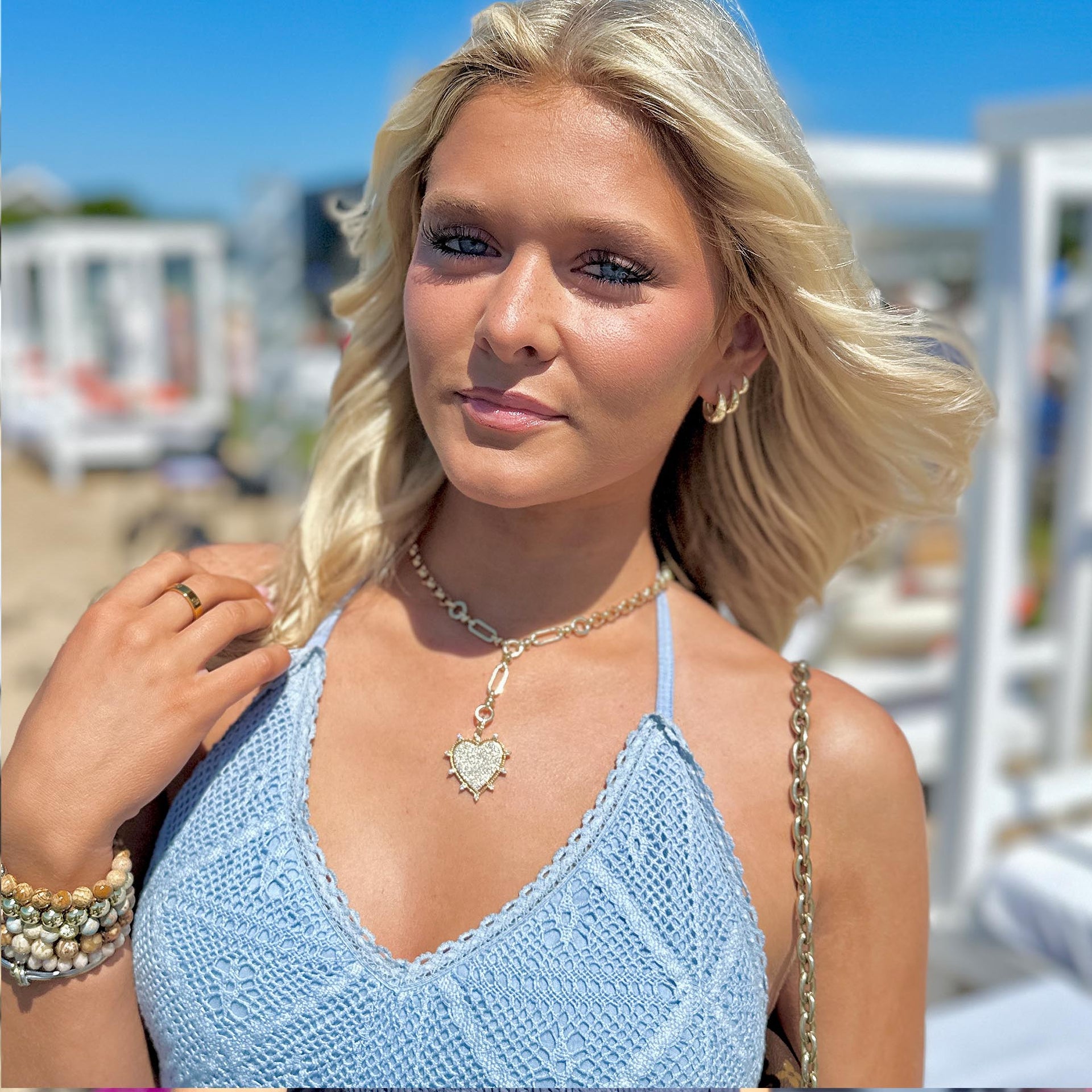 layla gold heart necklace on a model at the beach