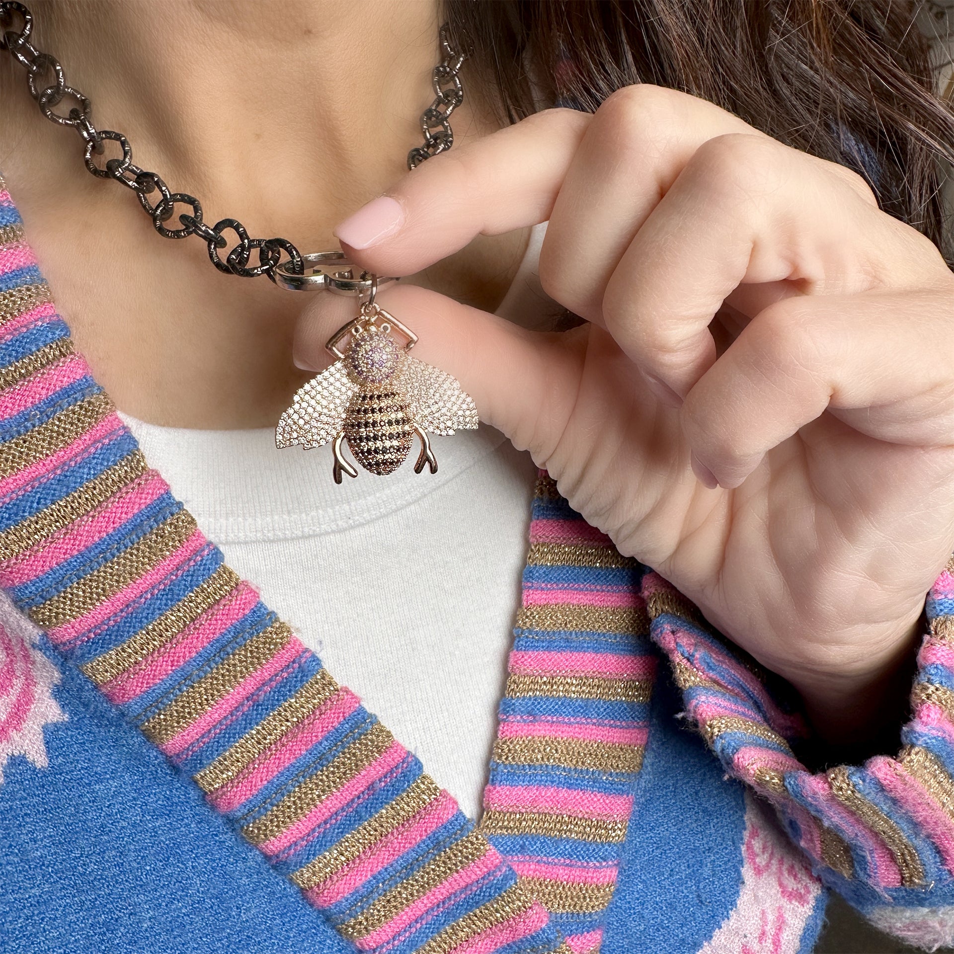 The Rose Gold Queen Bee Charm is pure glam. Soft rose sparkle meets rich golden undertones for a warm, radiant finish. Feminine, fierce, and full of boss energy. Shown on a model.