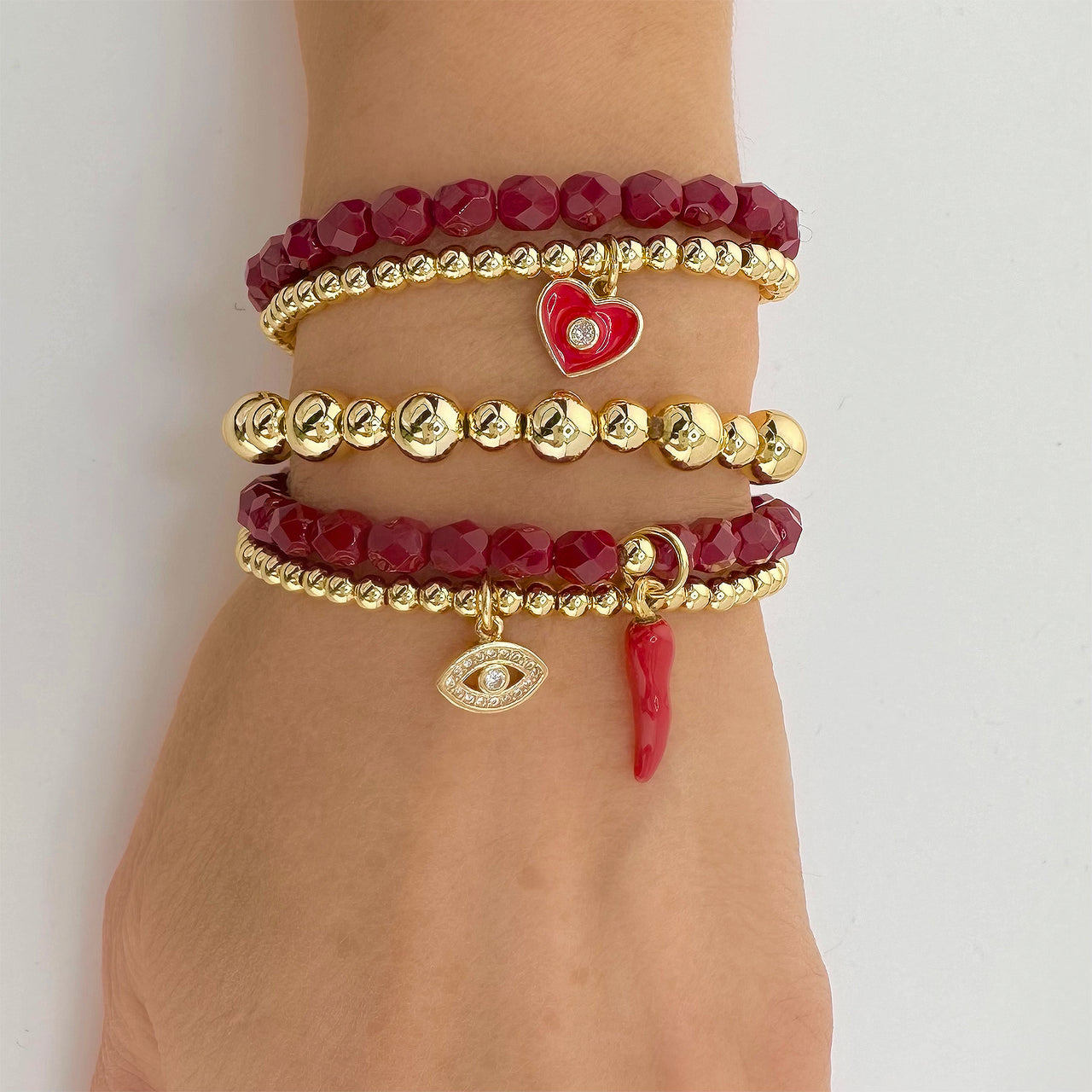Love Lisa Italian horn beaded bracelet stacked with charm bracelets red cornicello protection style