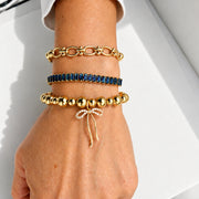 Love Lisa Trae Baguette Crystal Link Bracelet worn on wrist in a layered bracelet stack with colorful crystal and bead bracelets