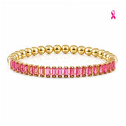 Love Lisa Trae Breast Cancer Awareness Pink Baguette Tennis Bracelet with vivid pink rectangular crystals and polished gold-tone round beads on white
