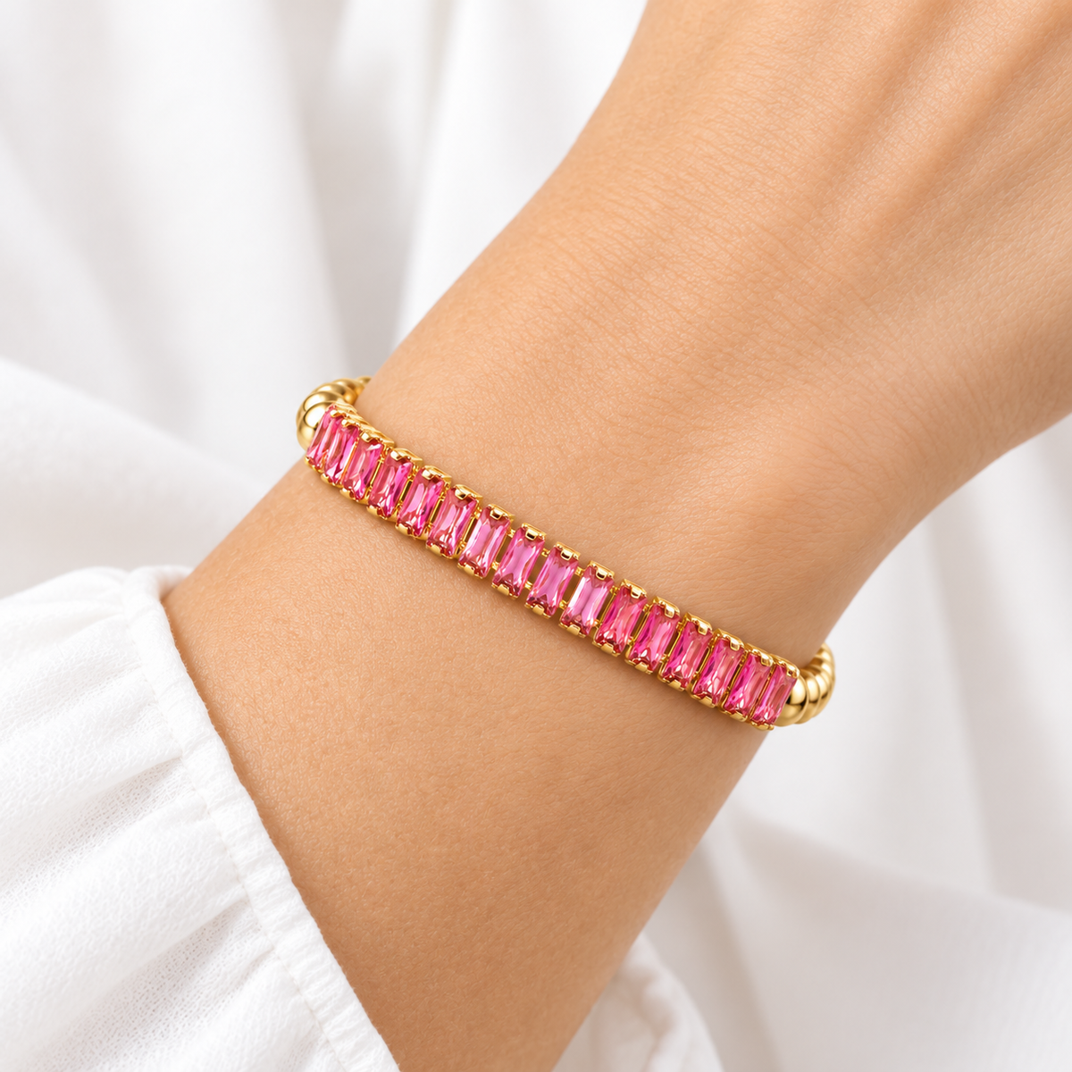 Love Lisa Trae Pink Baguette Breast Cancer Awareness Bracelet worn on wrist with bright pink crystals and polished gold-tone beads