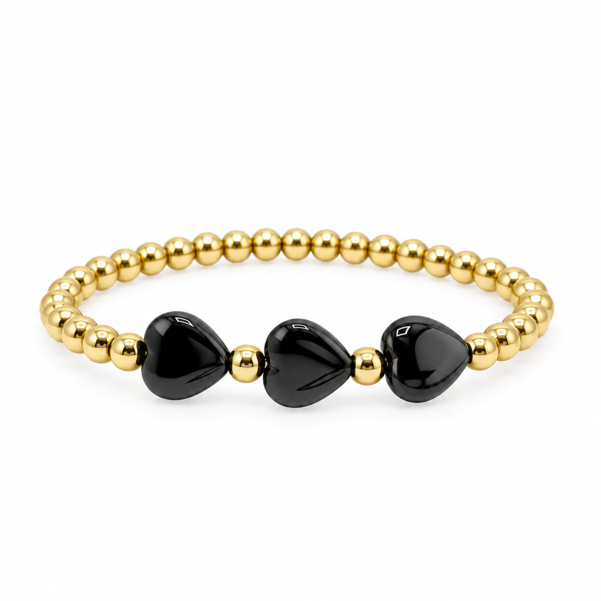 riple Mini Heart Worry Stone Bracelet with three glossy black heart-shaped stones and polished gold-tone round beads