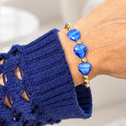 Love Lisa Triple Mini Heart Worry Stone Bracelet worn on wrist with three bright blue heart-shaped stones and polished gold-tone beads
