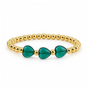 Triple Mini Heart Worry Stone Bracelet with three deep green heart-shaped stones and polished gold-tone round beads