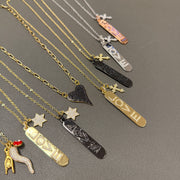 Trisha cross love tag necklace detail showcasing crystal LOVE pendant and pavé cross charm