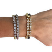 Love Lisa Val Tennis Beaded Bracelet styled on wrist stacked with beaded bracelets for layered jewelry looks