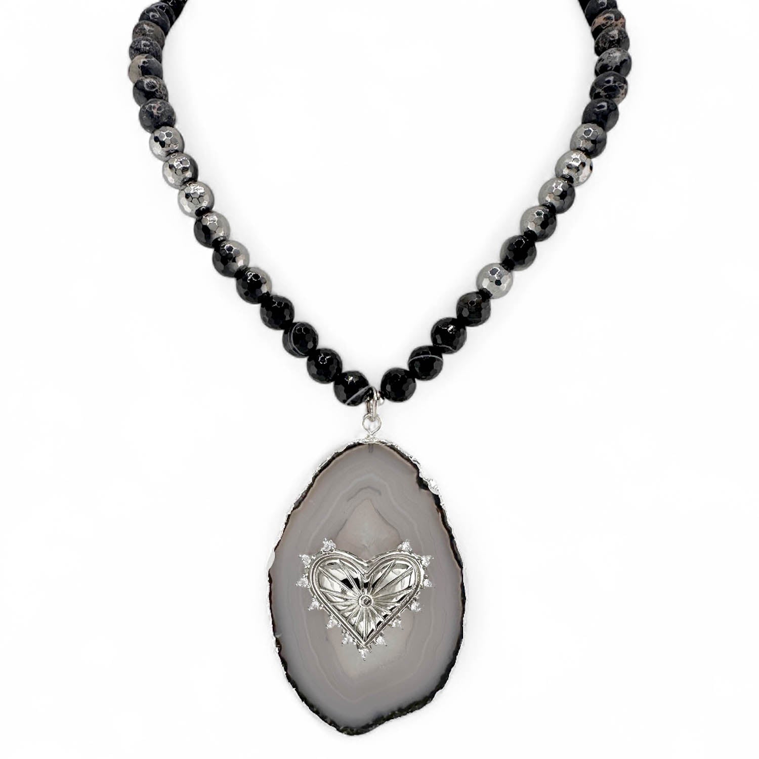 Necklace with black and gray bead chain and heart-shaped pendant on a white background