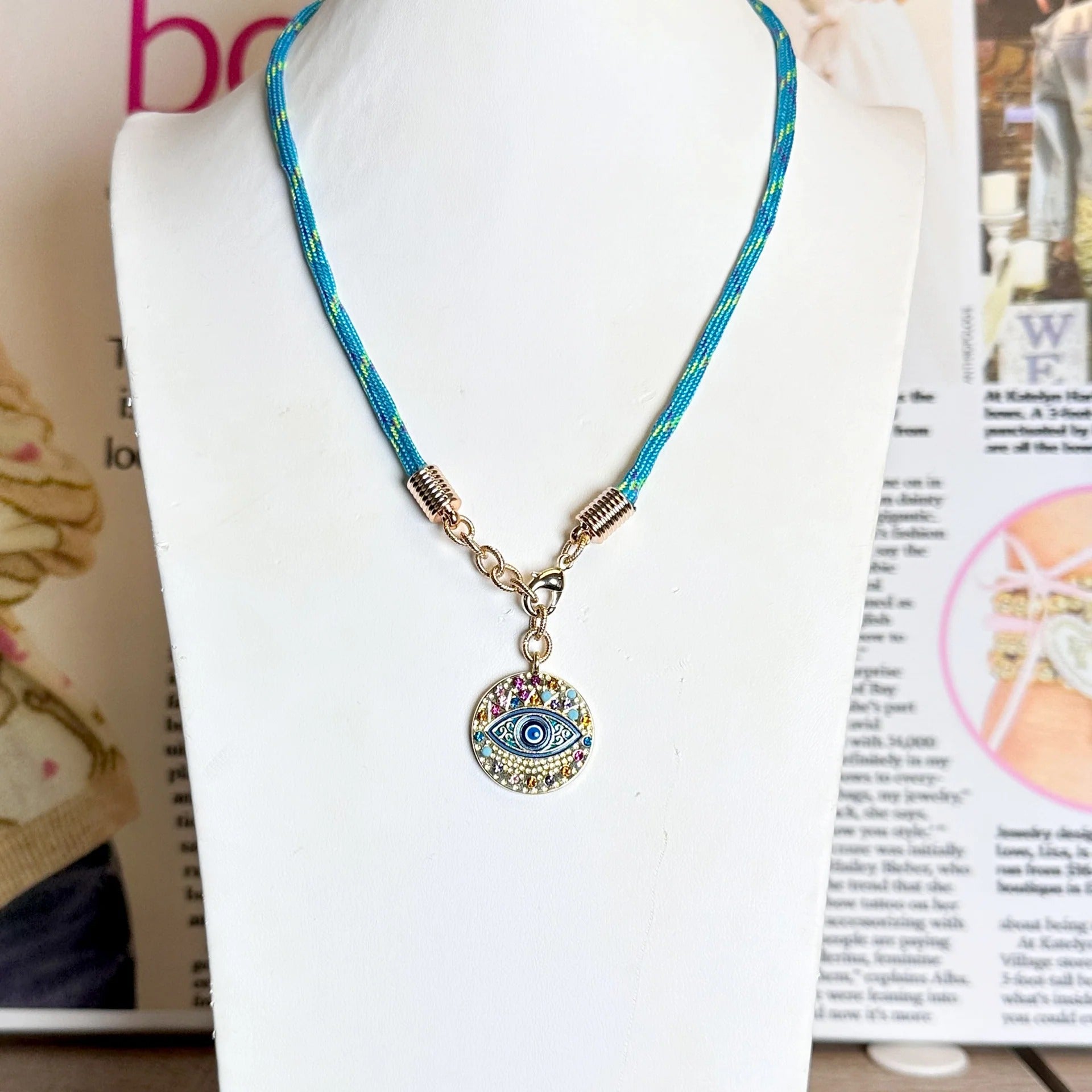 Vera coin charm on a paracord necklace