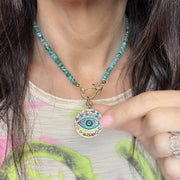 Vera evil eye charm shown on a necklace