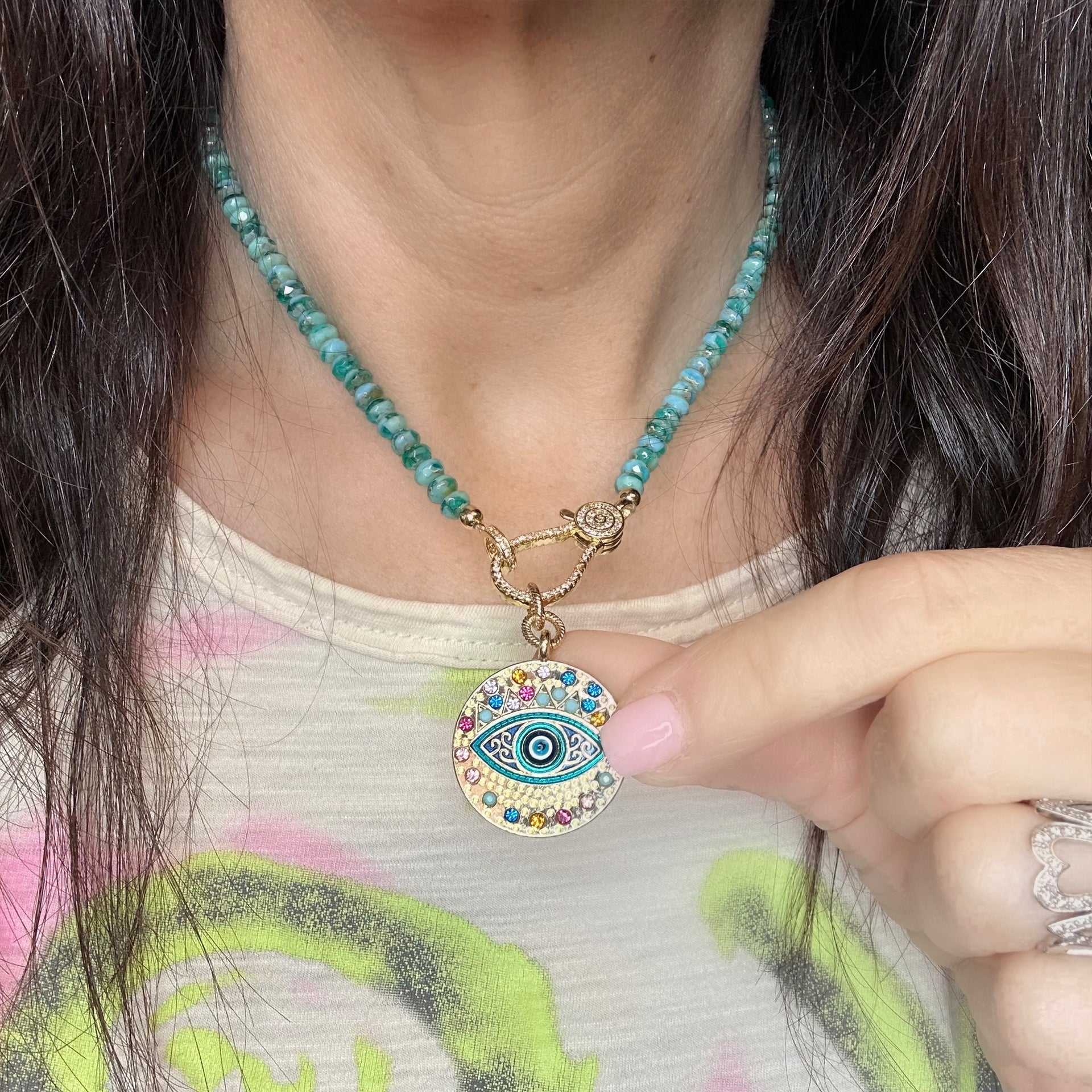 Vera evil eye charm shown on a necklace