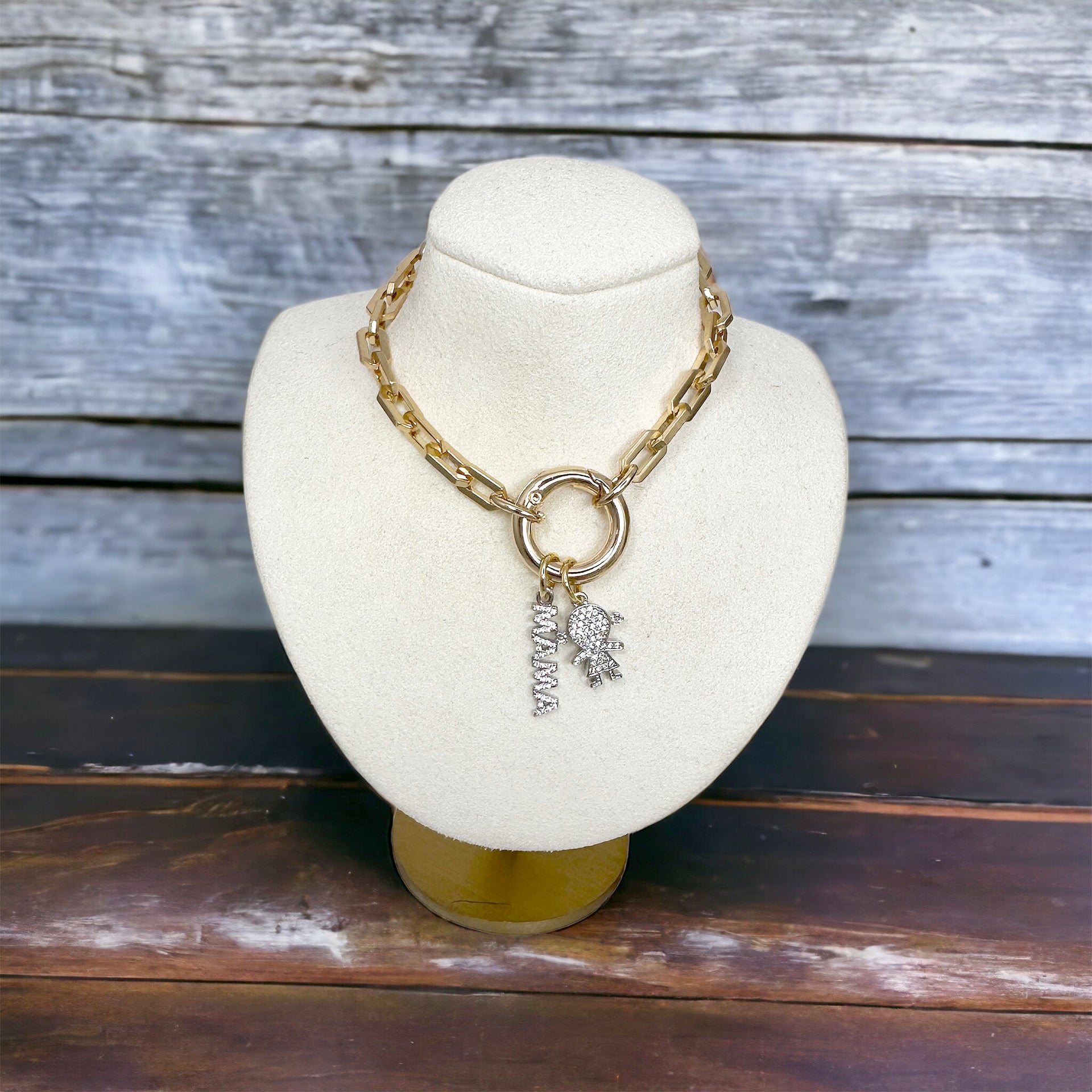 Love Lisa paperclip mom necklace layered with kids and mama charm on a display sentimental family jewelry