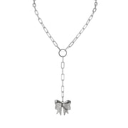 Silver necklace with a bow pendant on a white background