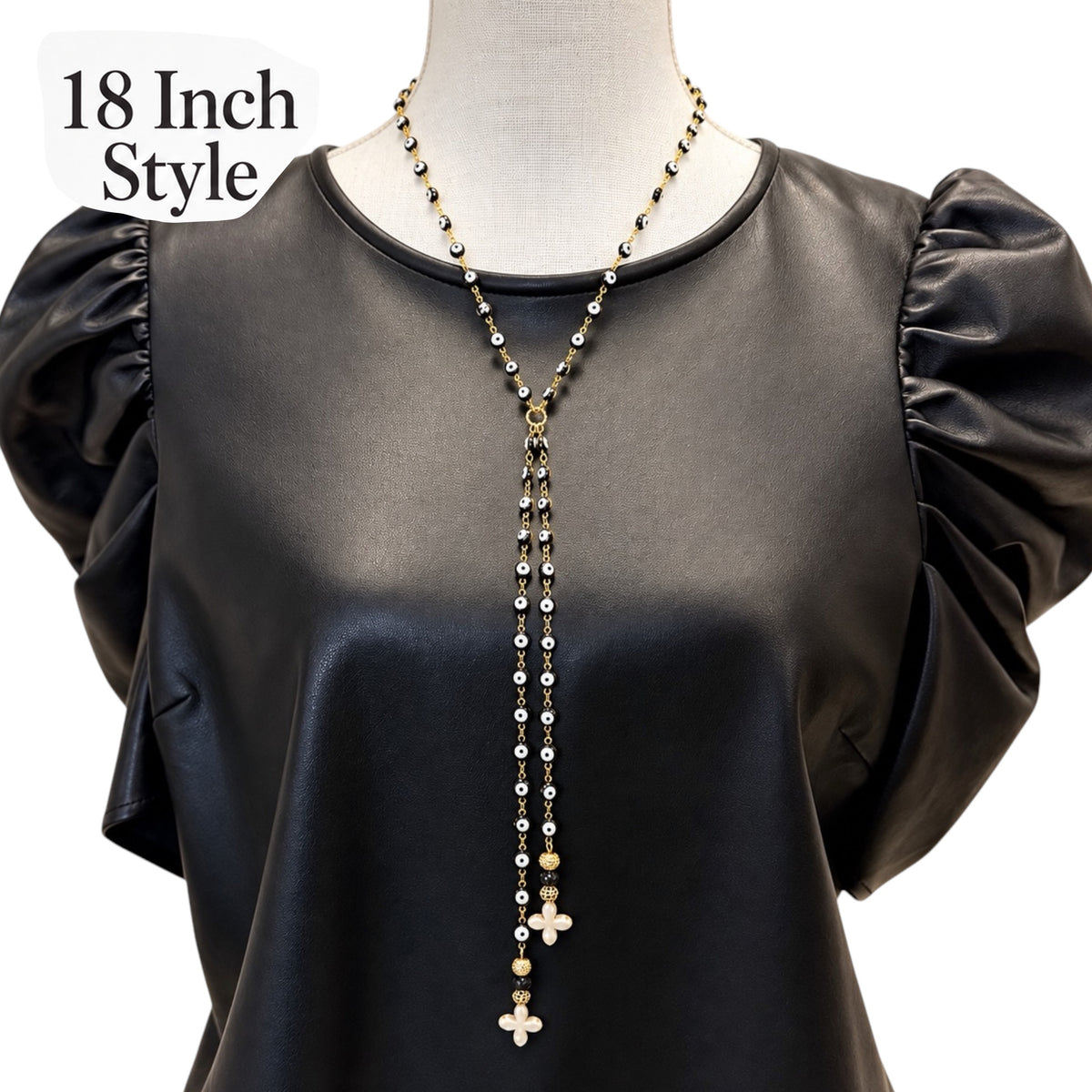 ove Lisa Vittoria 18-inch Y Necklace worn at the neckline with evil eye beads, two dangling strands, and howlite quatrefoil drops