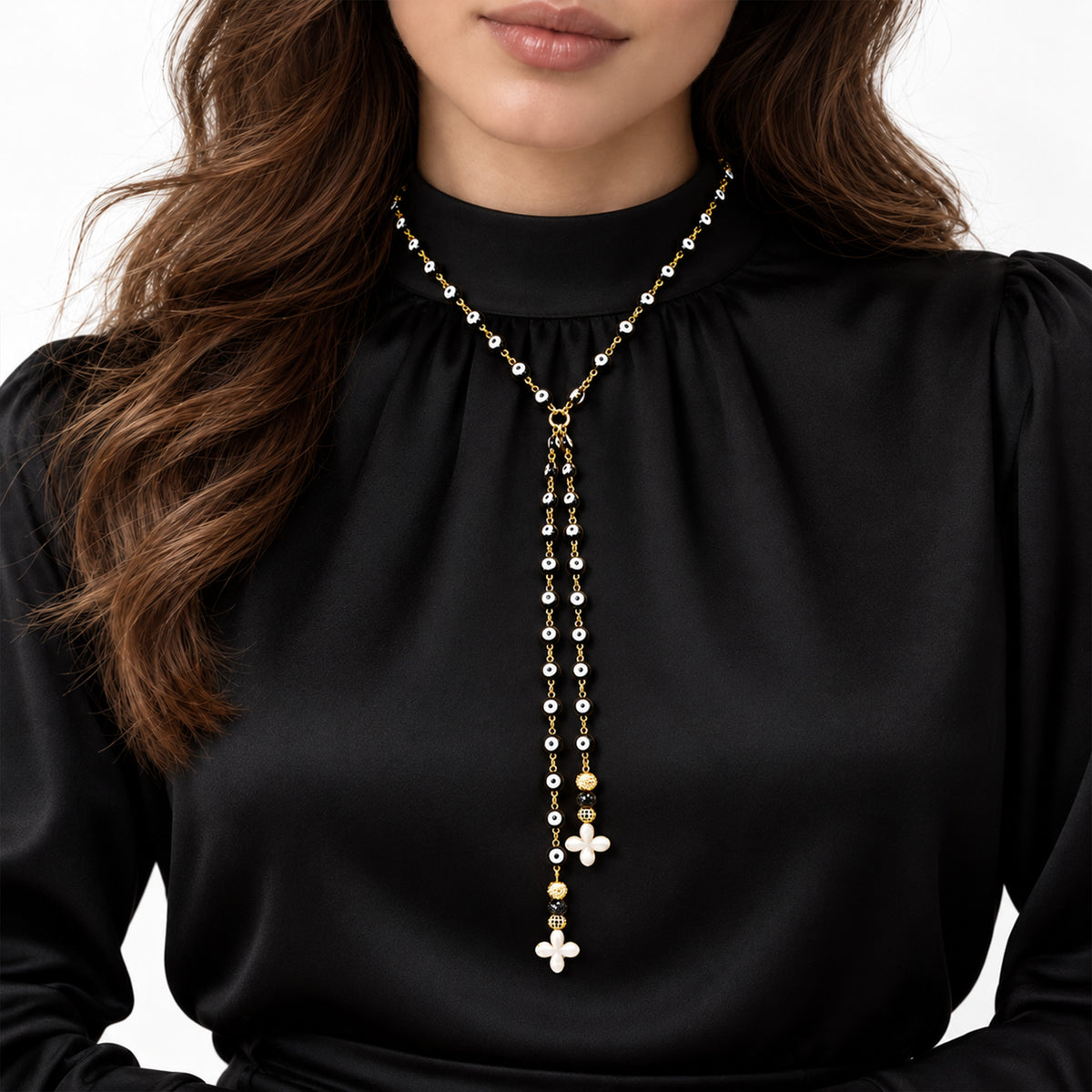 Love Lisa Vittoria 18-inch Y Necklace worn at the neckline with evil eye beads, two dangling strands, and howlite quatrefoil drops