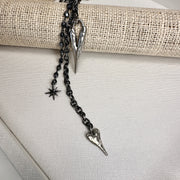 vixon necklace with dangling charms and starburst pendant