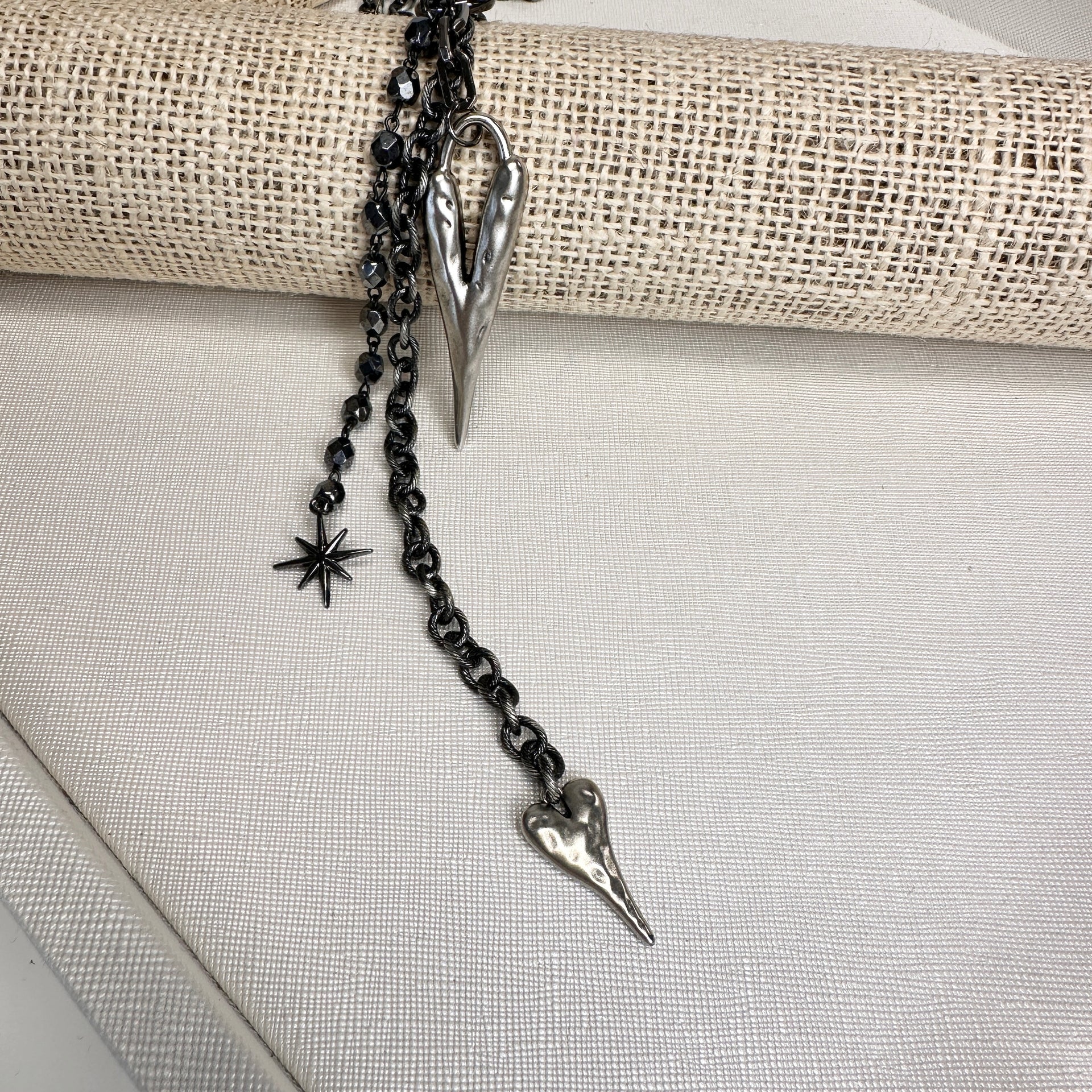 vixon necklace with dangling charms and starburst pendant