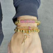 Love Lisa Ivy Luxe Pavé Bar Bracelet on model wrist layered with other bracelets

