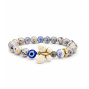Wish & Wonder Butterfly Sea Sediment Jasper Bracelet in Dream with blue beads, white howlite butterfly, blue evil eye bead, pavé crystal bead, and gold-tone crystal flower accent bead
