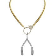 Gold chain necklace with a silver wishbone pendant on a white background
