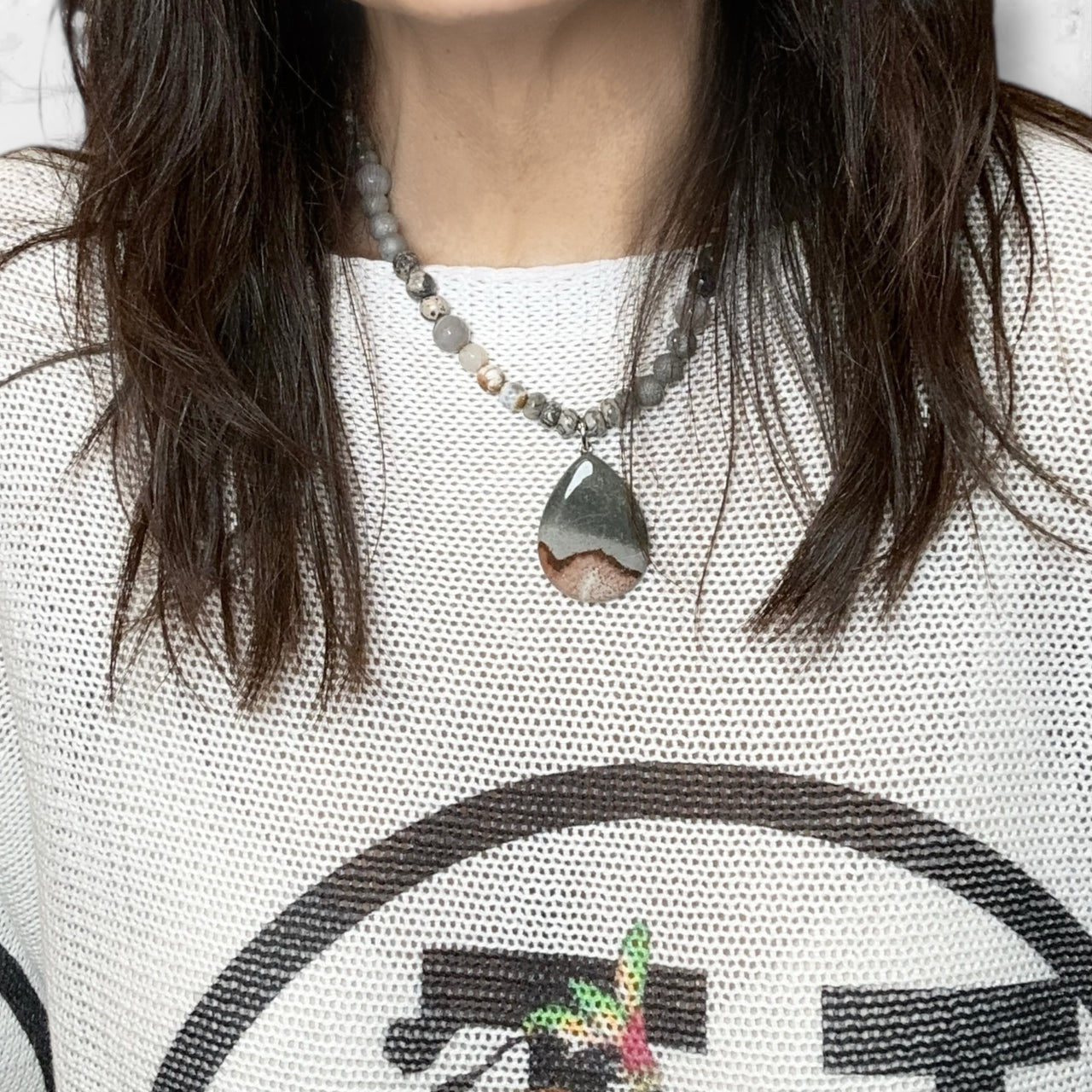 Love Lisa Worry Stone agate Oval Necklace layered on model gemstone jewelry for mindfulness