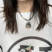 Love Lisa Worry Stone agate Oval Necklace layered on model gemstone jewelry for mindfulness