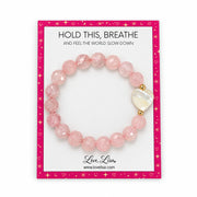 Love Lisa Rose Quartz Mother of Pearl Worry Stone Bracelet displayed on a pink Hold This Breathe awareness card with faceted pink beads and heart focal
