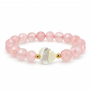 Love Lisa Worry Stone Rose Quartz Mother of Pearl Bracelet with faceted blush pink beads, iridescent heart focal, and small gold-tone accent beads on white
