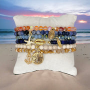 andrea starfish beaded anklet blue gemstone and gold starfish charm photographed on sand love lisa jewelry