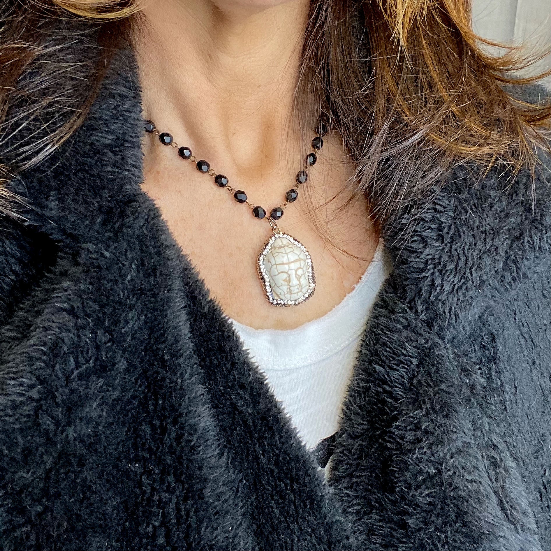 peaceful buddha pendant necklace styled on fur