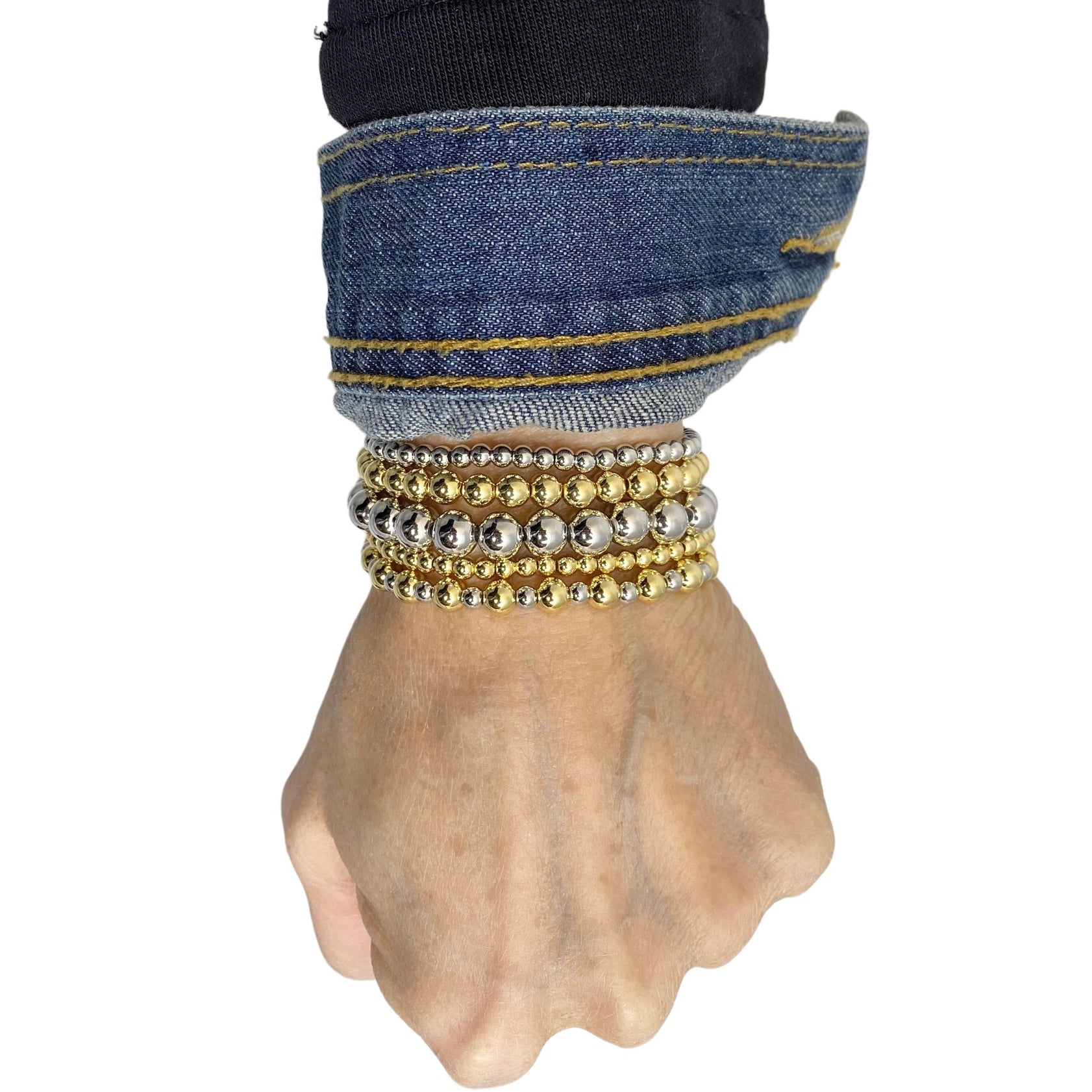 celebrity famous five stack of beaded bracelets gold and silver stacked on wrist by love lisa jewelry