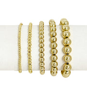 Celebrity Five beaded bracelet stack in gold with five polished stretch bead bracelets