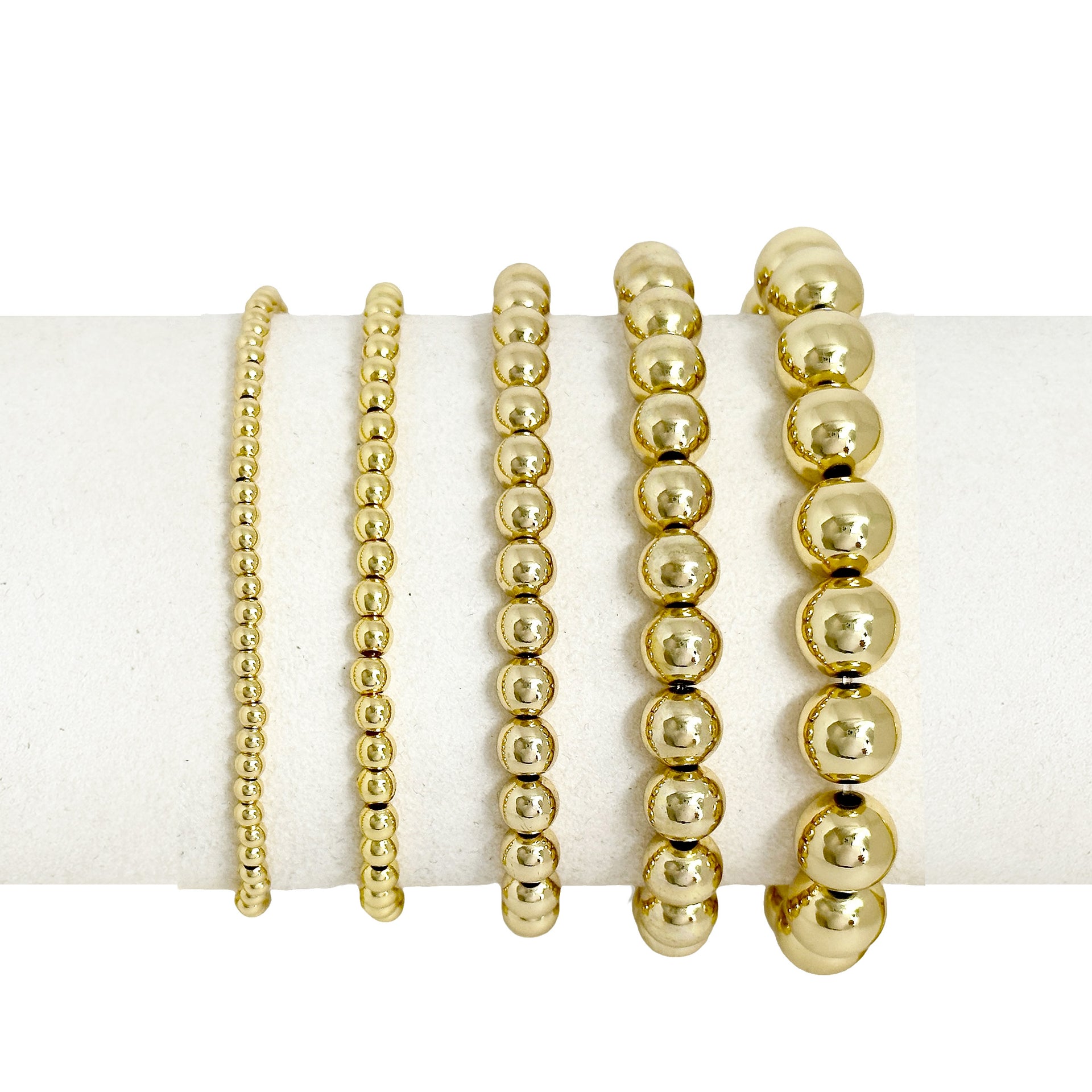 Celebrity Five beaded bracelet stack in gold with five polished stretch bead bracelets