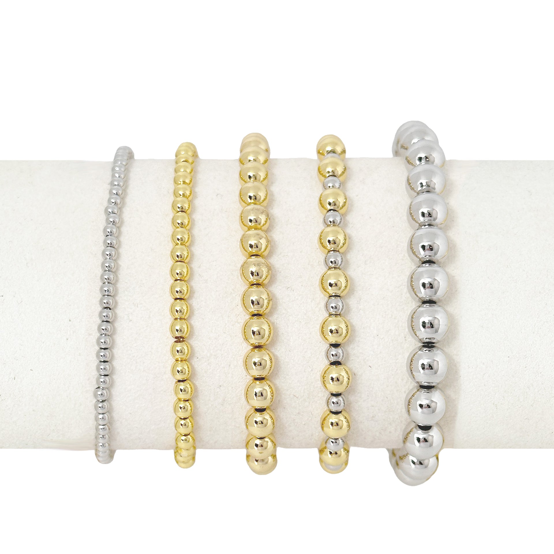 celebrity famous five stack of beaded bracelets gold and silver stack on pillow by love lisa jewelry