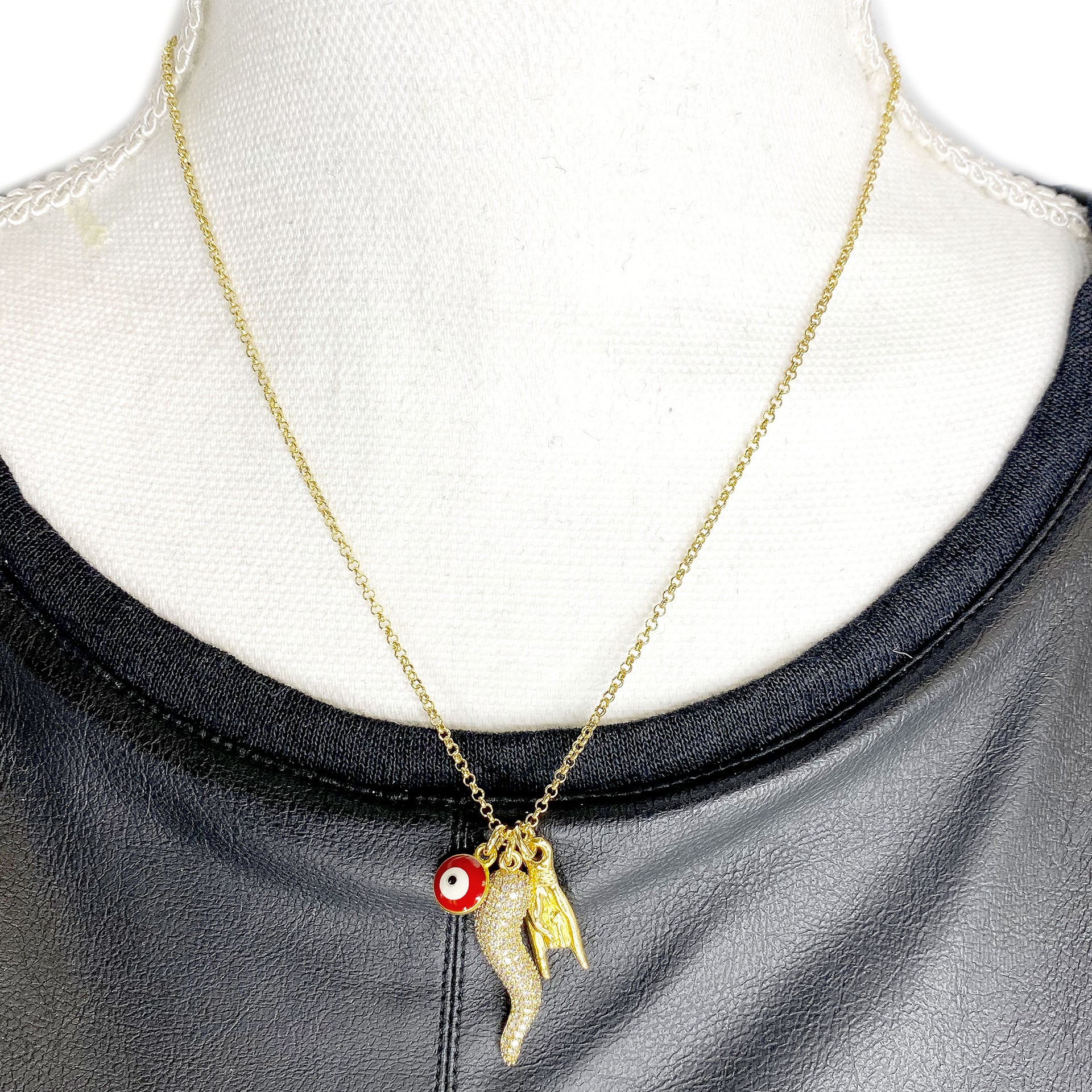gold Italian horn necklace with CZ horn evil eye and hand charms displayed on necklace bust