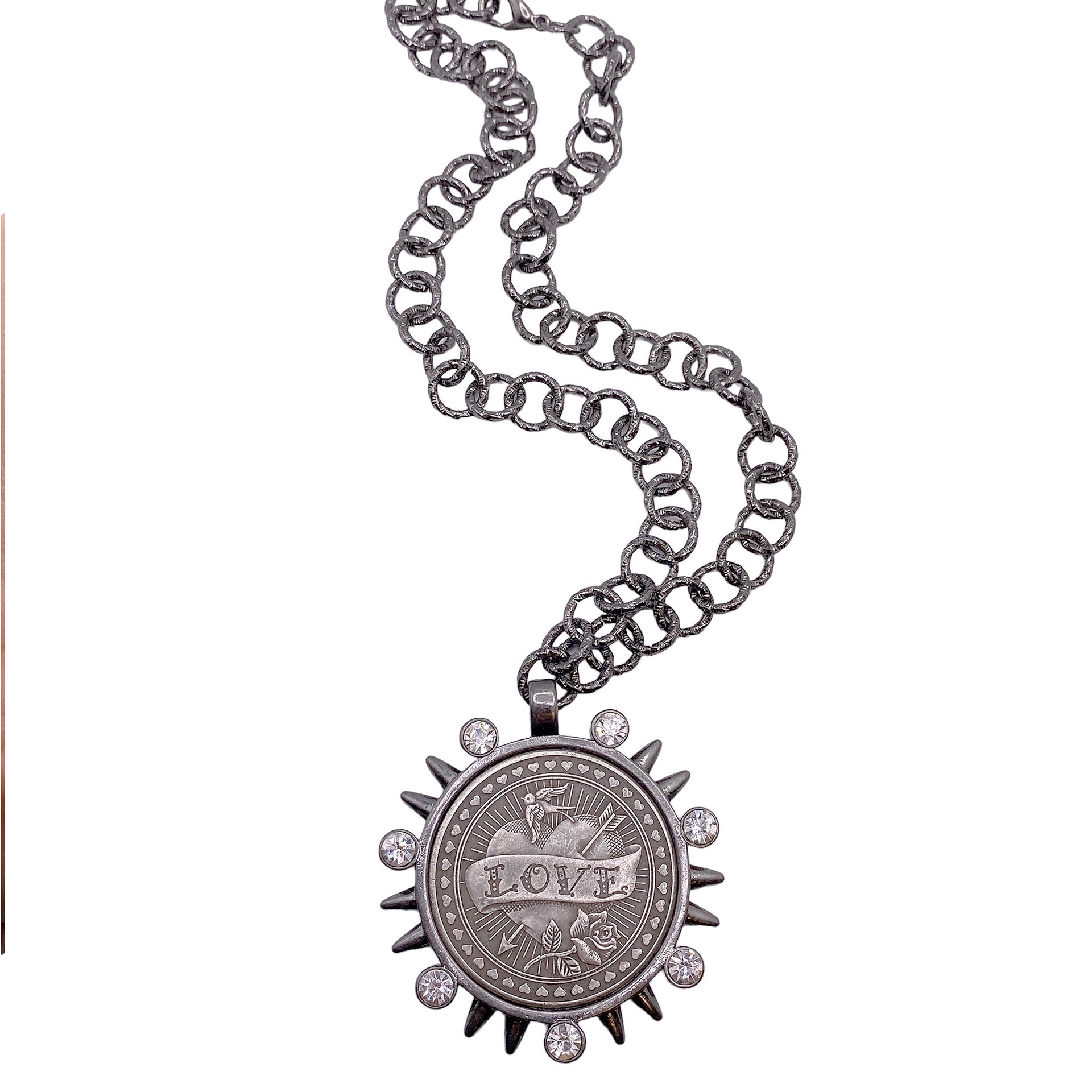 flat lay of black chain necklace with heavy LOVE coin pendant and spike details
