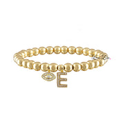 A gold-colored bracelet with a series of round beads and a letter 'M' with a sparkling stone on it.
