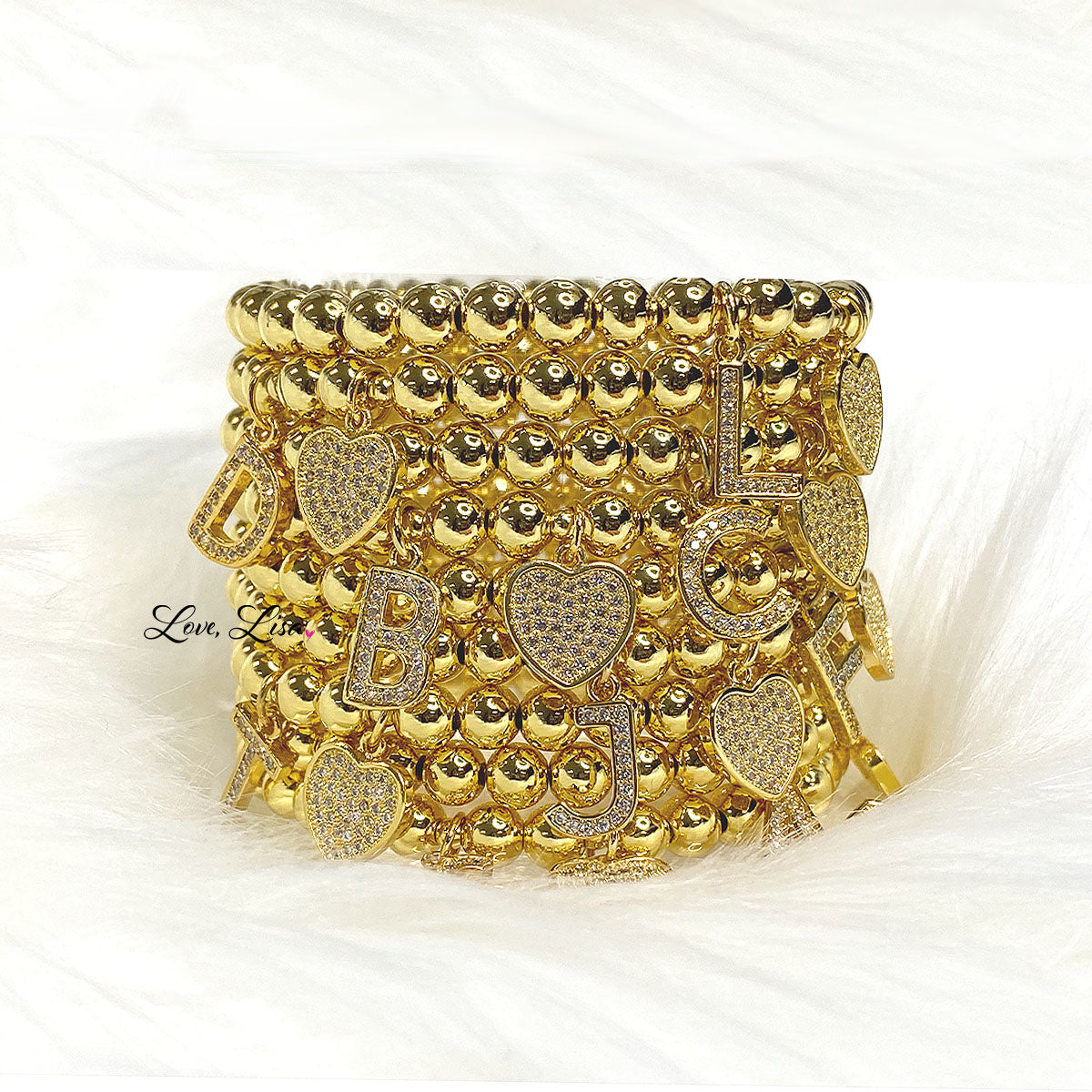 stack of Love Lisa Milania sweet initial personalized beaded bracelets
