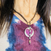 model wearing milly necklace with pink heart pendant