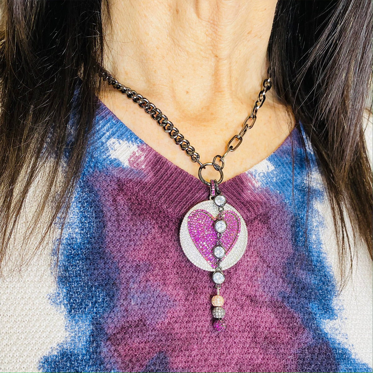 model wearing milly necklace with pink heart pendant