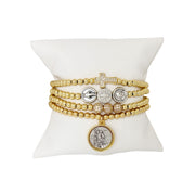 Love Lisa gold bracelet stack featuring Saint Michael medal charm