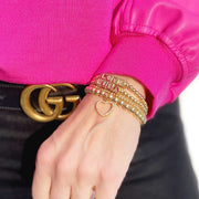 woman wearing personalized block letter bracelets stacked with gold and silver beads by love lisa