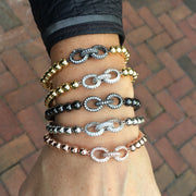 Love Lisa Silvania’s Link Bracelet in gold with pavé infinity charm on wrist