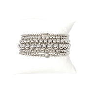 A series of six silver beaded bracelets stacked together, featuring a variety of round beads.