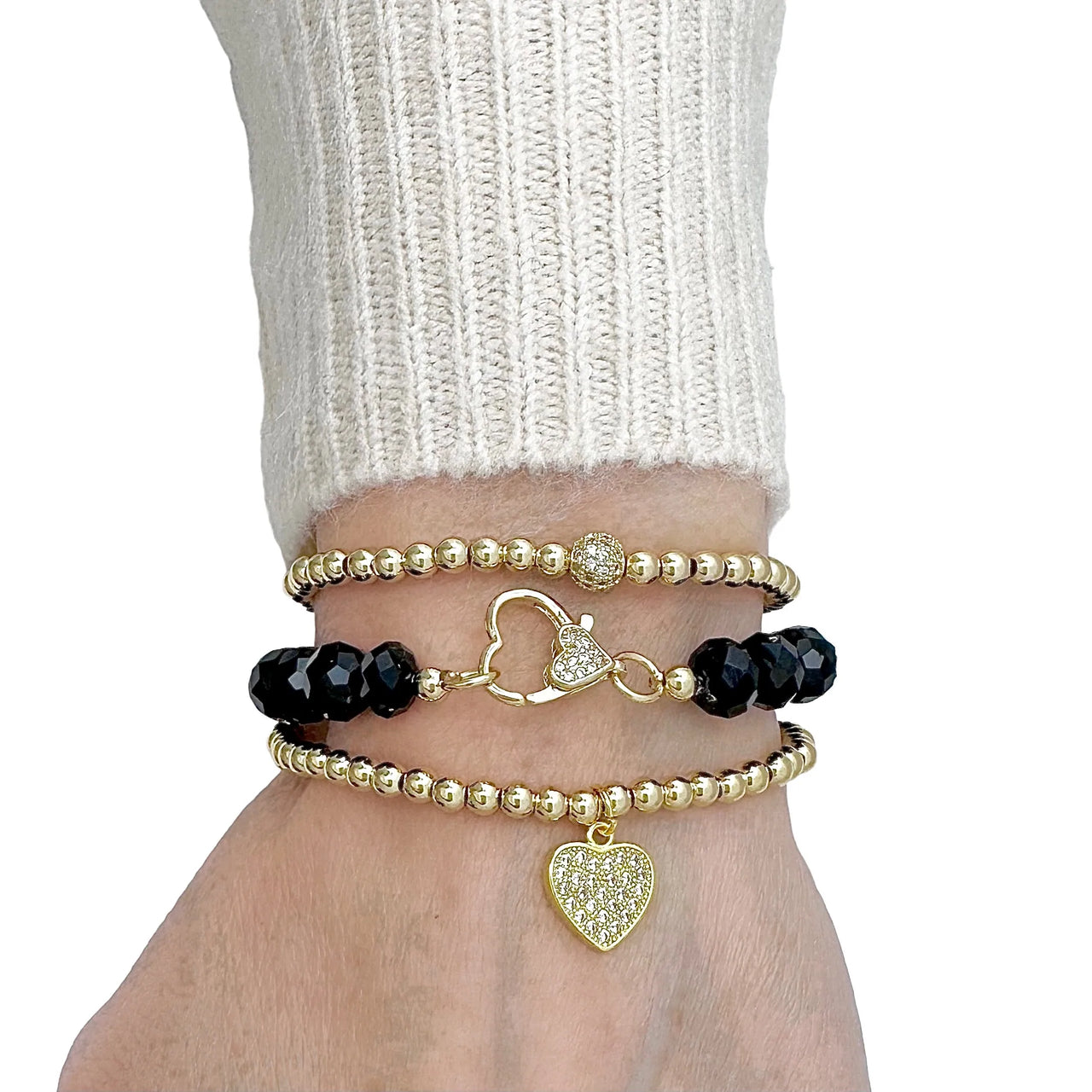 Love Lisa heart charm beaded bracelet worn on wrist layered with stretch bracelets